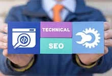 Person in a suit holding a card with three sections a web development icon, Technical SEO text, and a gear and wrench symbol, conveying technical SEO concepts.